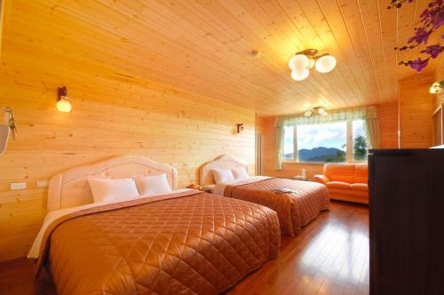 a bedroom with two beds and a couch at Sea of Clouds Vacation Villa in Renai