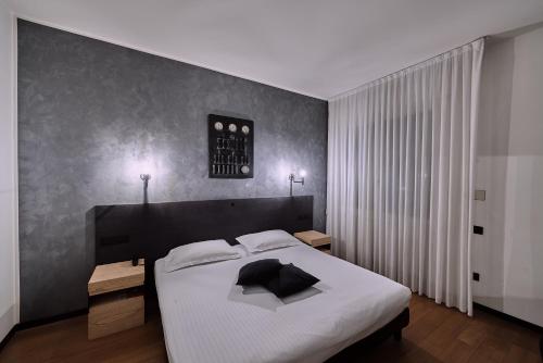 a bedroom with a large bed with a black headboard at Hotel Miramonti in Schio