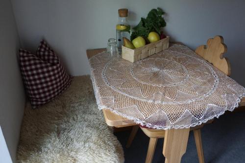 a table with a bowl of apples and a bottle of wine at BUEHLERHOF Agriturismo, Obst-&Weingut, Urlaub mit Hund, Bauernhof, Brixen in Rosa