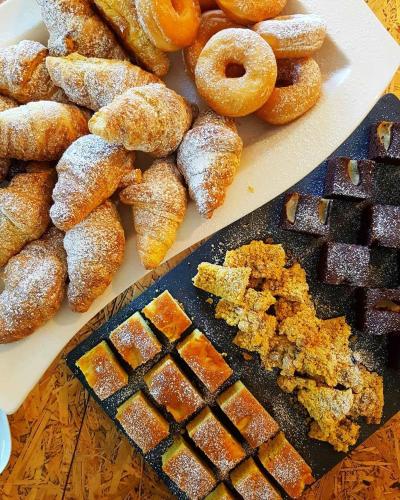 a bunch of donuts and other pastries on a table at Aiden by Best Western JHD Dunant Hotel in Castiglione delle Stiviere