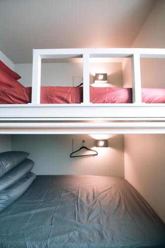 two bunk beds in a room with a floor at Daegu Midtown Hostel in Daegu
