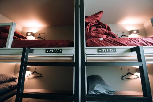 two bunk beds in a room with two shelves at Daegu Midtown Hostel in Daegu