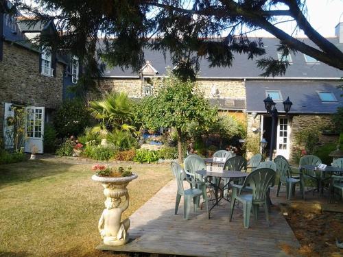 eine Terrasse mit einem Tisch und Stühlen im Hof in der Unterkunft La Pastourelle Chambre d Hôtes in Saint-Méloir-des-Ondes