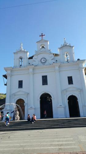 a white church with people sitting in front of it at Apartamento Acogedor en el Retiro in El Retiro