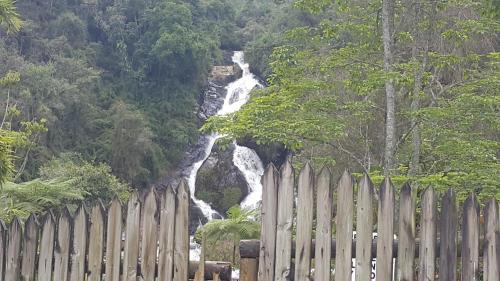 a waterfall behind a fence in front of a water fall at Apartamento Acogedor en el Retiro in El Retiro