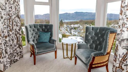 a room with two chairs and a table and a window at Windermere Hillthwaite Hotel in Windermere