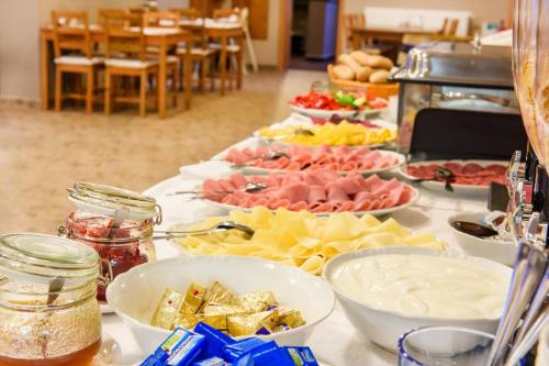 a table with many plates of food on it at Apartmány Dolní Morava in Dolní Morava