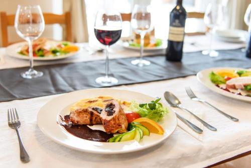 a table with plates of food and glasses of wine at Apartmány Dolní Morava in Dolní Morava