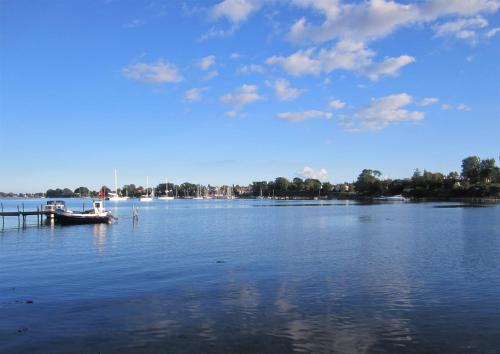 a boat is docked on a large body of water at Tåsinge B&B in Svendborg