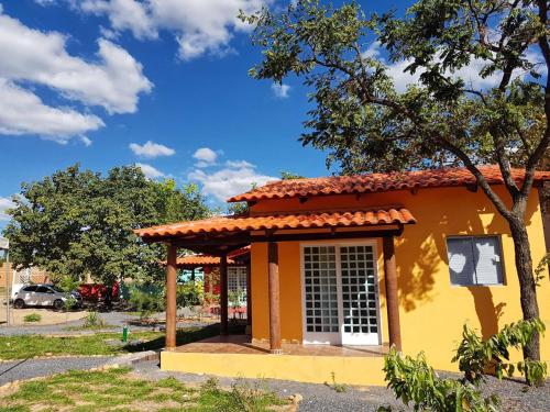 a small yellow building with a red roof at Mambaí Inn in Mambaí