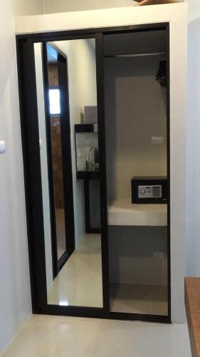 a mirror on a wall in a room at Baan Fran Sim Da in Bang Tao Beach