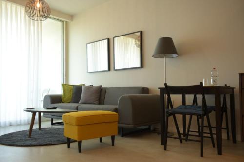 a living room with a couch and a table at Different Atmosphere Suite in Caesarea
