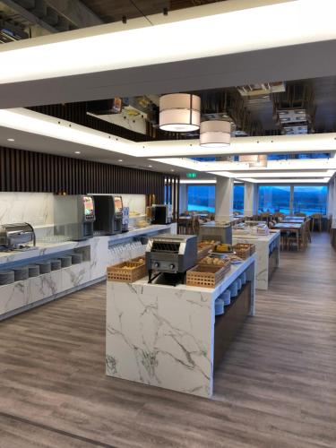 a large kitchen with marble counter tops and tables at Hotel do Parque in Viana do Castelo