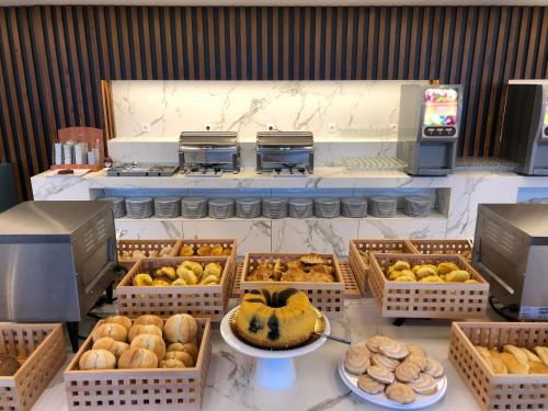 a bakery with many baskets of different types of bread at Hotel do Parque in Viana do Castelo