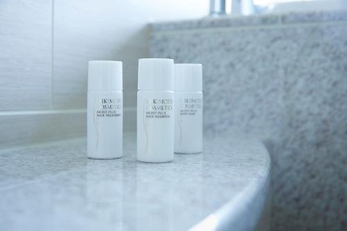 three bottles of sunscreen sitting on top of a counter at Shima Kanko Hotel The Classic in Shima