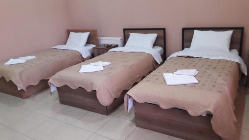 two beds in a room with towels on them at Ideal in Akhalk'alak'i