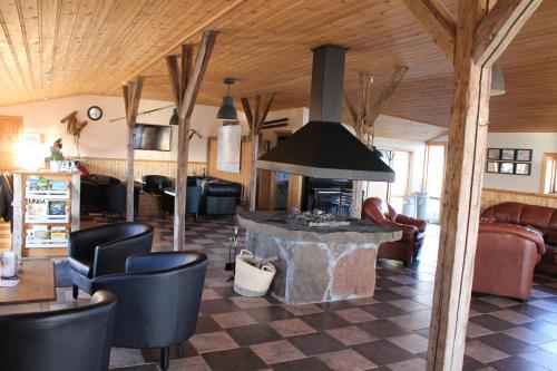 a living room with a fireplace in a house at Hótel Á in Reykholt