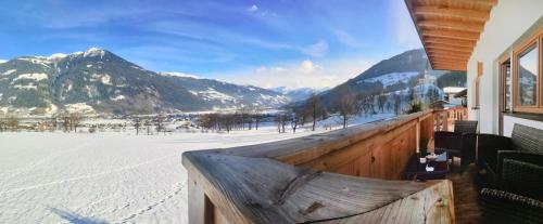 a balcony with a view of a snowy mountain at Wiesennest in Fügenberg