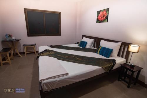 a bedroom with two beds in a room at Ming Shou Boutique House in Phuket Town