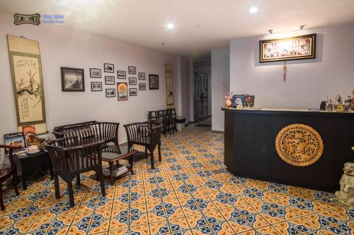 a waiting room with chairs and a bar in a restaurant at Ming Shou Boutique House in Phuket Town
