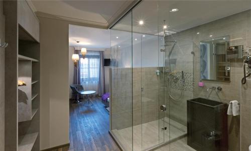 a bathroom with a shower with a glass door at Ambiance Hotel - Braunau - Simbach in Braunau am Inn