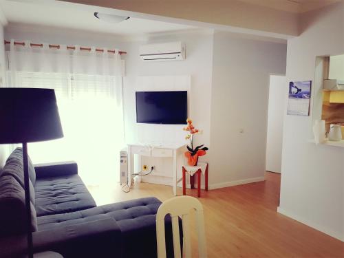 En tv och/eller ett underhållningssystem på Squash Club Apartamentos