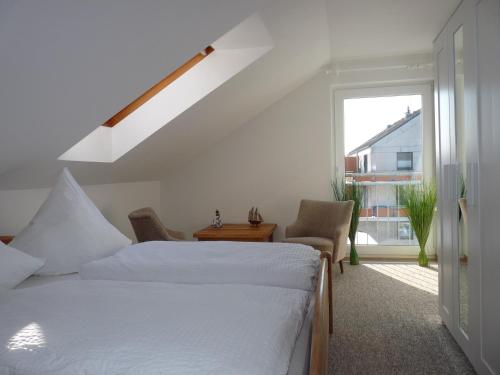 a bedroom with a bed and a window at Pension Haus Baltic in Dahme