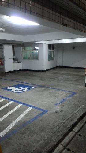 an empty parking garage with blue paint on the ground at 貴都飯店-Crystal Hotel Taipei in Taipei
