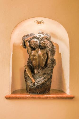 a bronze statue of a woman on a wall at Ambiance Hotel - Braunau - Simbach in Braunau am Inn