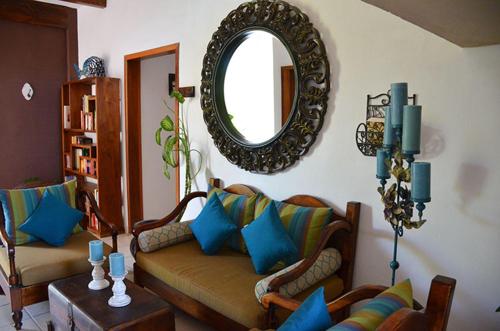 a living room with two couches and a mirror at La Pasion Colonial Hotel Boutique By Bunik in Playa del Carmen