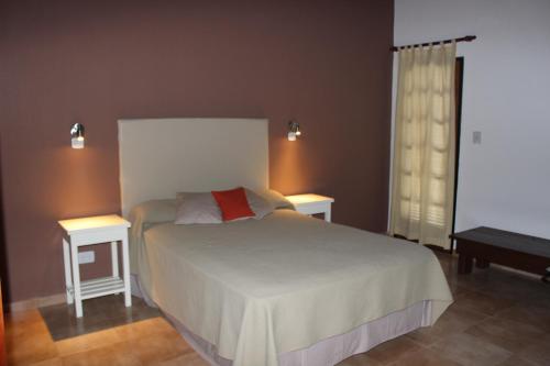 En eller flere senge i et værelse på Villa Leandro