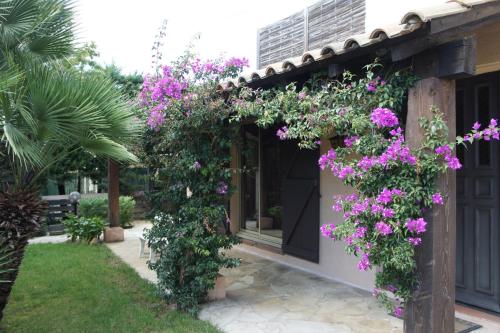a house with flowers on the side of it at Villa Bruyere in Antibes