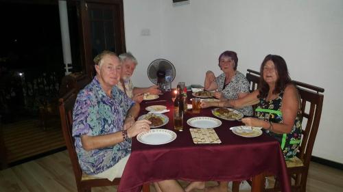 a group of people sitting at a table eating food at DiNi Galle in Galle