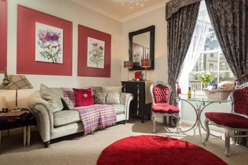 a living room with a couch and a table at The Bonnie Bide Awa' in Edinburgh