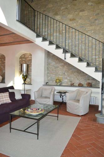 a living room with a couch and a stair case at Casalta Di Pesa in Siena