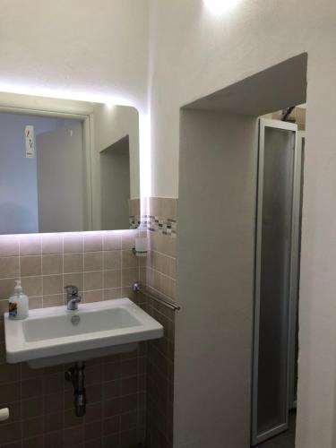 a bathroom with a sink and a mirror at Florence Dalmazia Fast Check In on line in Florence