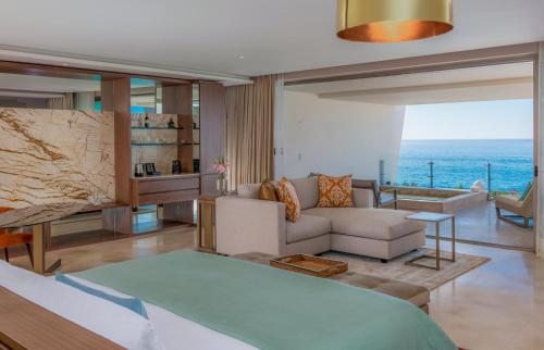 a living room with a view of the ocean at Grand Velas Los Cabos Luxury All Inclusive in Cabo San Lucas