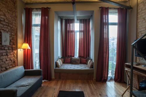 a living room with a couch in front of windows at Peradays in Istanbul