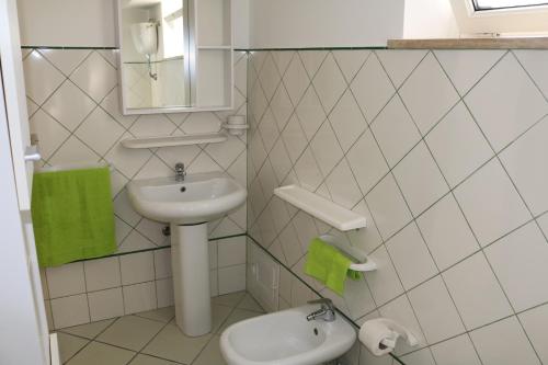 a small bathroom with a sink and a toilet at Le Case dei Pescatori - Coccinella Rossa in Ponza
