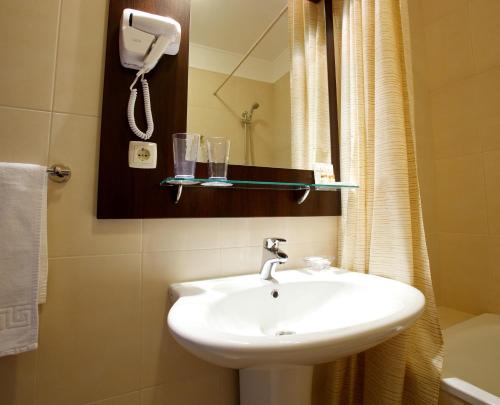 a bathroom with a sink and a shower at CityClub Hotel in Tiraspol