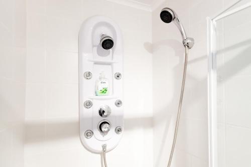 a shower with a shower head in a bathroom at Madragoa - PLUS in Lisbon