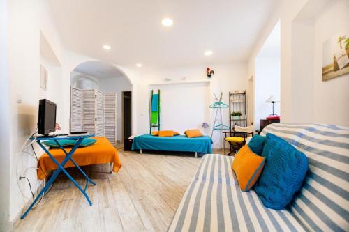 a room with two beds and a television in it at Madragoa - PLUS in Lisbon