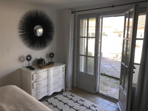 a bedroom with a white dresser and a mirror at Maison l'Etrier in Saintes-Maries-de-la-Mer