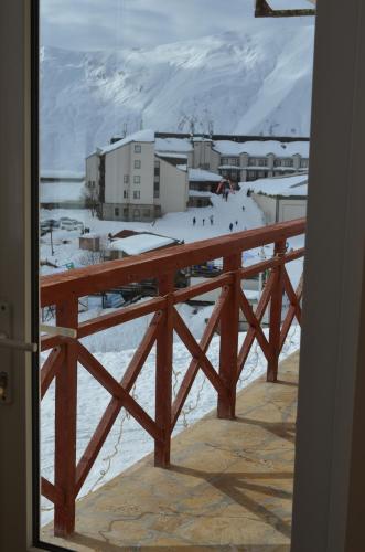 a view of a snow covered city from a window at Hotel Toni in Gudauri