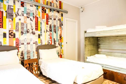 two beds in a room with skis on the wall at Hostel Trastevere in Rome