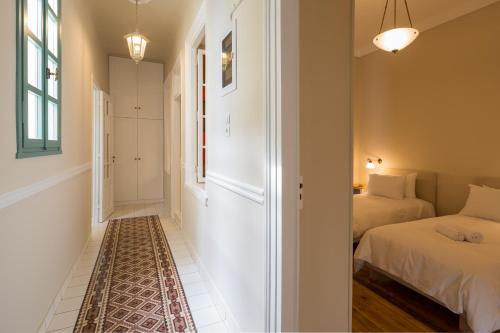 a bedroom with a bed and a hallway at Artdecoathens in Athens
