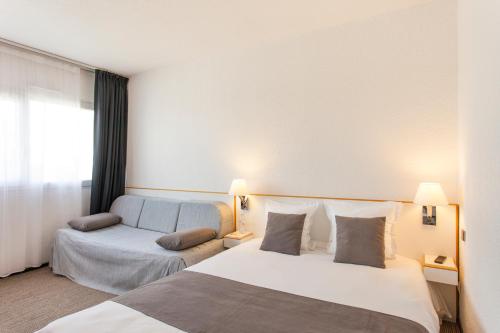Säng eller sängar i ett rum på Hôtel Villa Bellagio Blois by Popinns