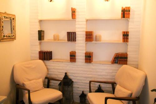 a living room with two chairs and a fireplace at La Pasion Colonial Hotel Boutique By Bunik in Playa del Carmen