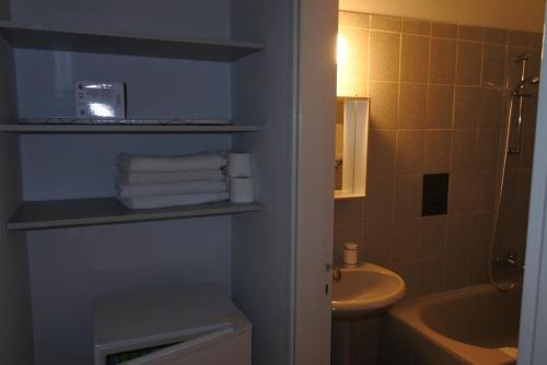 a bathroom with a sink and a toilet and a tub at Kissonerga beach apartment in Paphos