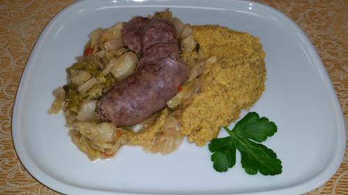 a plate of food with a sausage and rice at Hotel Victory in Taio